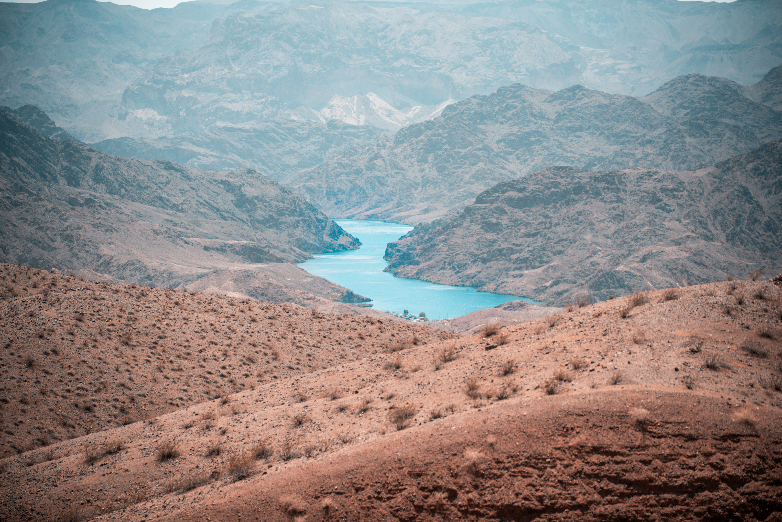The Colorado River bending through desert canyon mountains